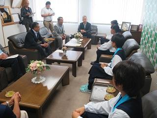原田市長と市役所を訪れた恵庭北高校陸上部の選手4人が懇談している写真